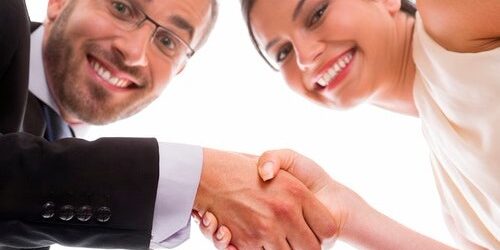 HappyHiring Happy people shaking hands after interviewing for a job