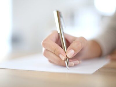 Woman writing her Career in Review