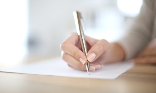 Woman writing her Career in Review