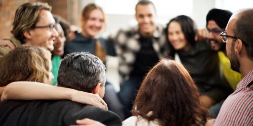 DiversityintheWorkplace Diverse team huddled together in the workplace