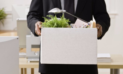 Fired Employee Leaving with Box of Personal Belongings