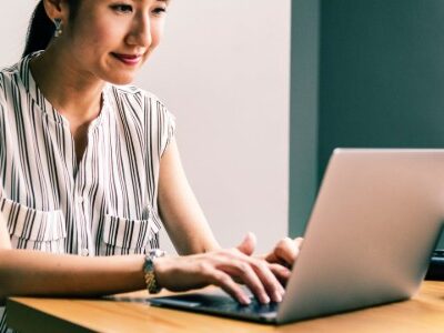 Woman sitting at a computer updating her resume for a career change