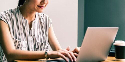 Woman sitting at a computer updating her resume for a career change