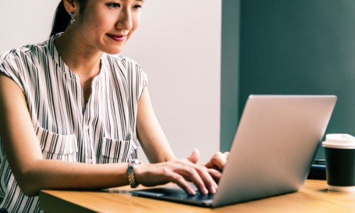 Woman sitting at a computer updating her resume for a career change